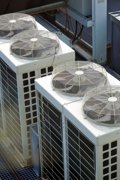 Modern white circular air vent on a ceiling for air management
